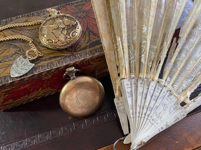 Necklaces, fan, and compass