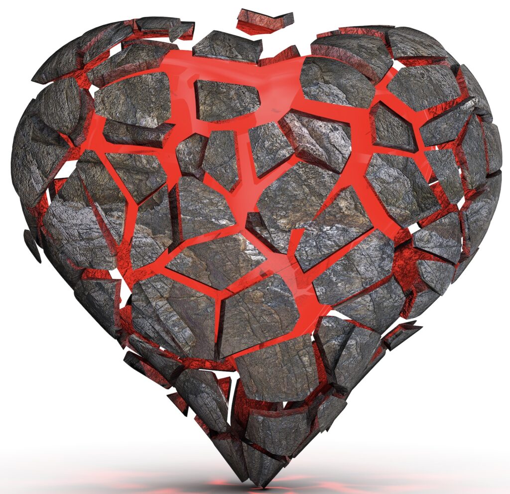 A red color heart illustration with broken pieces of stone