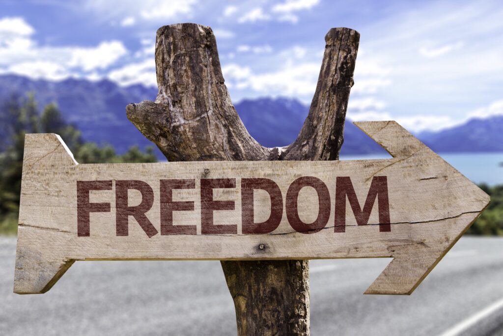 A wooden sign with the word freedom on it.